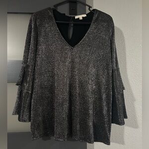 Black/silver quarter length bell sleeve top. Never worn. Size large.